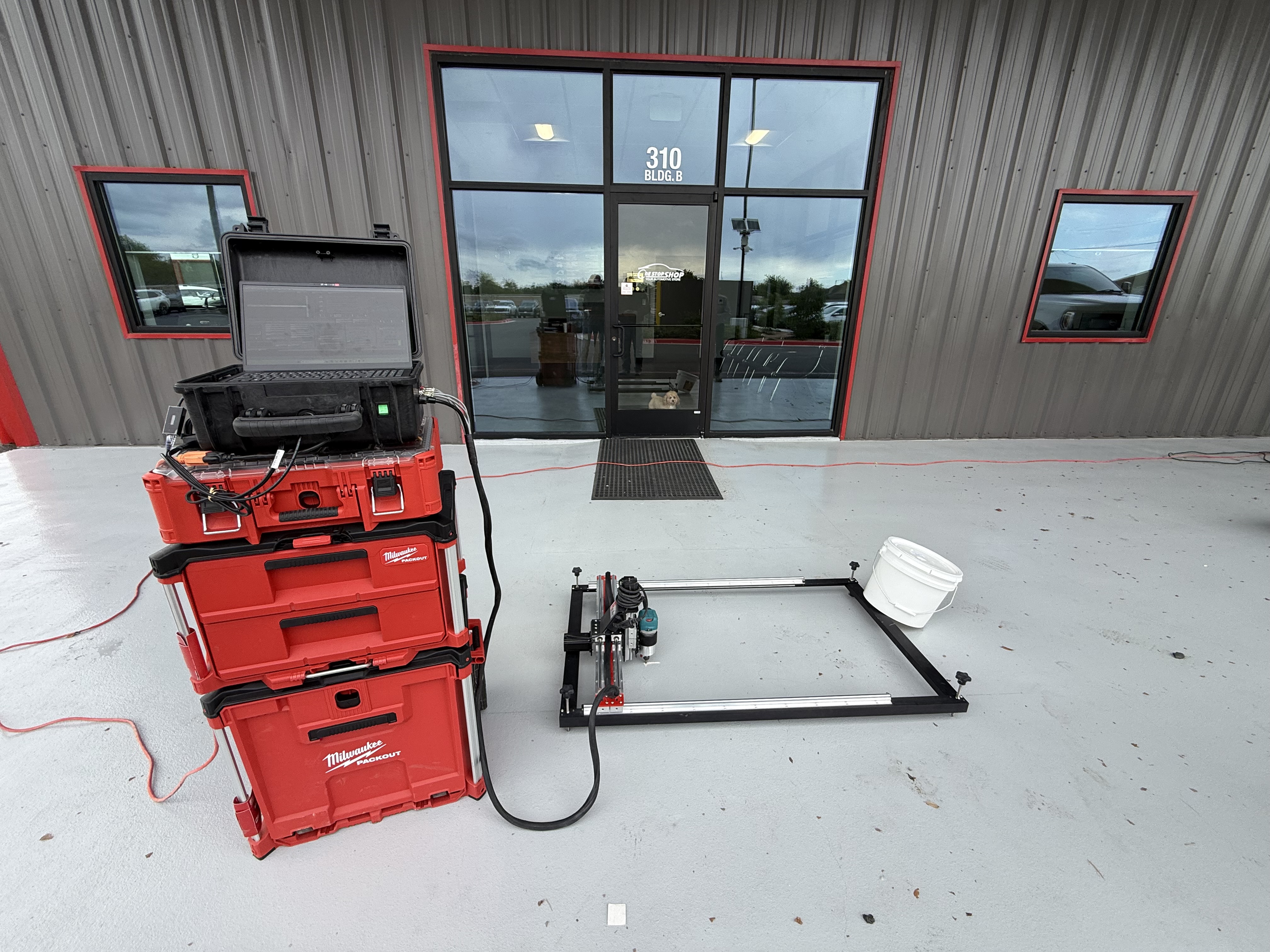 CNC concrete engraving machine and Milwaukee Packout setup on job site