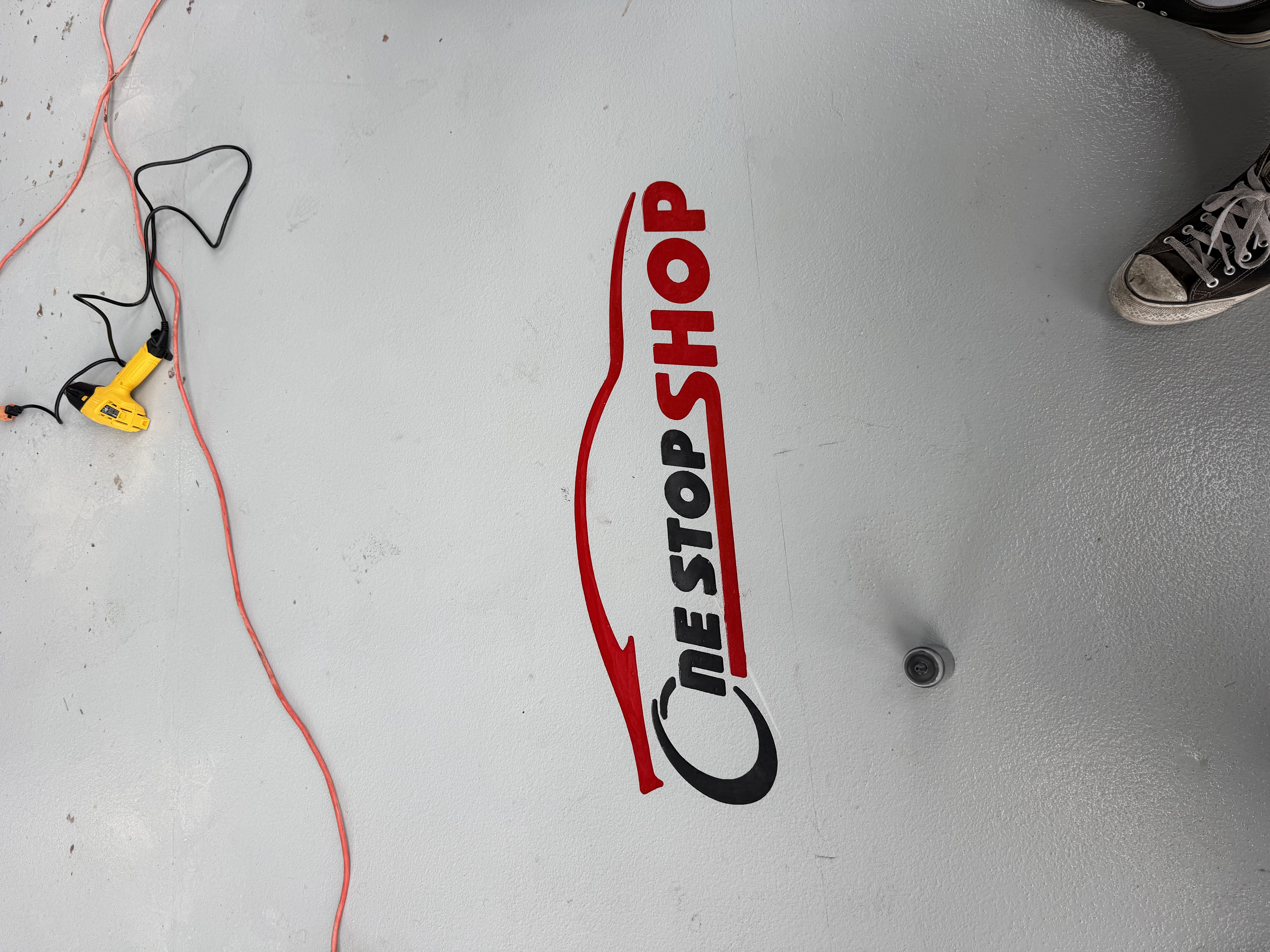 One Stop Shop logo engraved in concrete floor